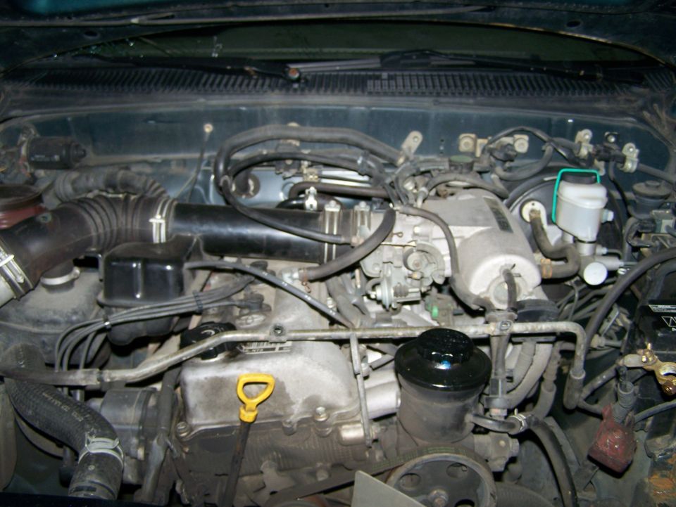 Engine bay with air intake and brake fluid reservoir