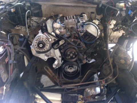 1994 Ford Bronco - Close-up view of an engine bay, showing the alternator, belts, and pulleys.