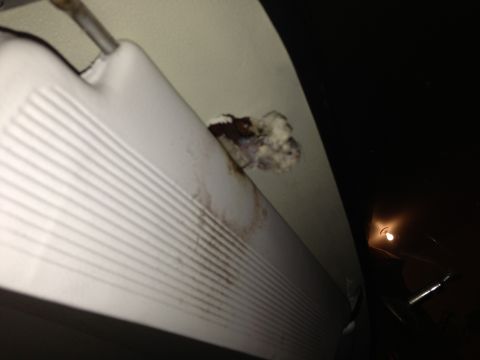 1964 Ford Fairlane - Debris is stuck to the car's interior ceiling near the sun visor.