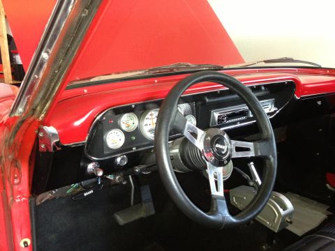 1964 Ford Fairlane - The interior of a 1964 Ford Fairlane shows a Grant steering wheel, custom gauges, and a floor shifter.