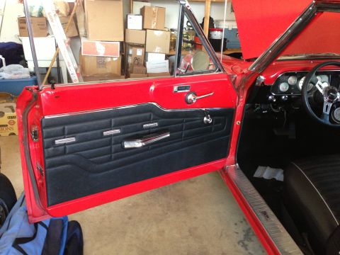 1964 Ford Fairlane - Interior view of a 1964 Ford Fairlane, focusing on the driver's side door panel and dashboard.