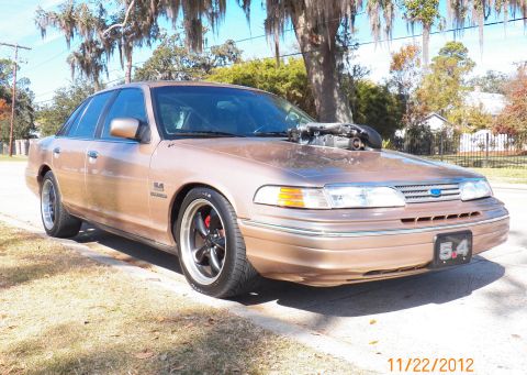 1993 Ford Crown Victoria - This modified 1993 Ford Crown Victoria features a prominent supercharger and custom wheels.