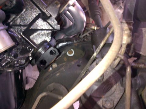 1994 Ford Bronco - Close-up view of an engine bay, focusing on the exhaust manifold and various hoses.