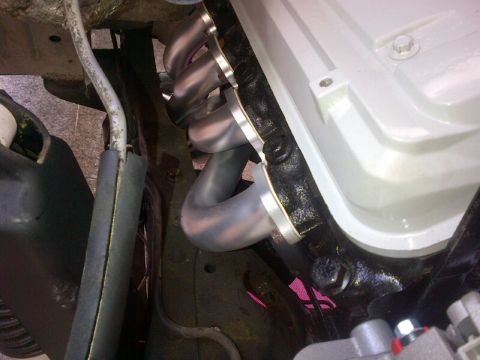 1994 Ford Bronco - Close-up view of engine exhaust headers and valve cover.
