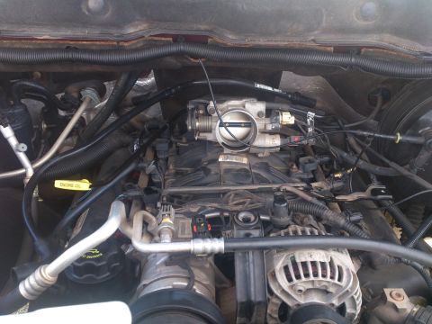 2004 Dodge 1500 - The engine bay of a 2004 Dodge 1500, with visible components like the throttle body and alternator.