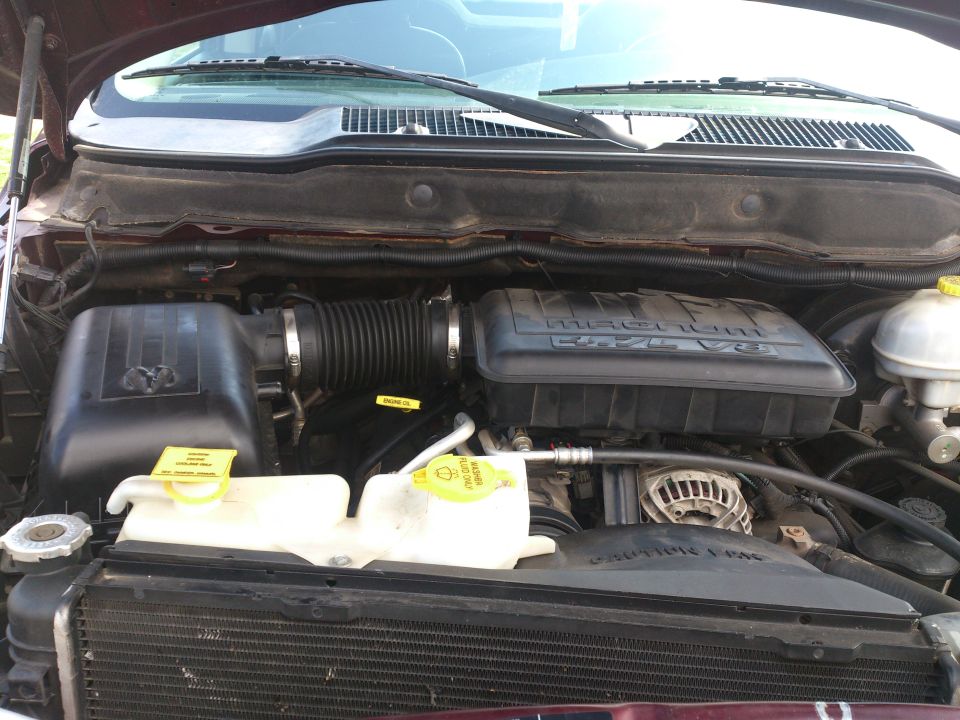 Engine bay of a 2004 Dodge 1500 with Magnum V8 engine cover
