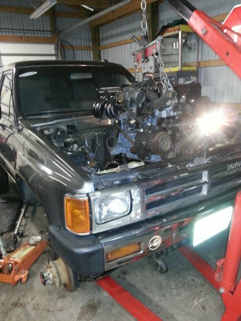 1987 Toyota 4Runner - Engine is being lifted out of a 1987 Toyota 4Runner in a workshop.