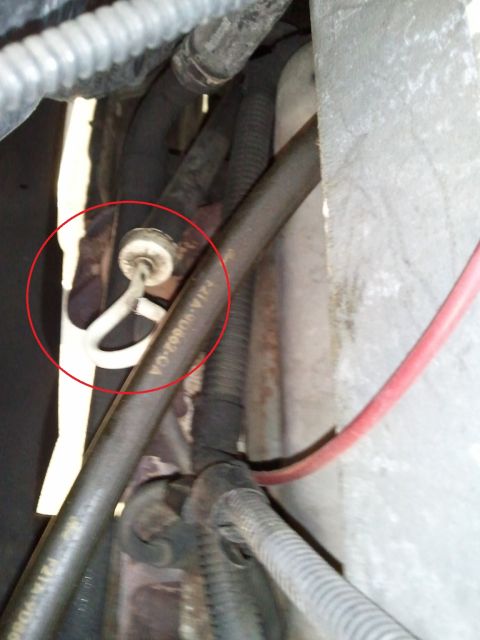 1994 Ford Bronco - Detail of an automotive AC system component, possibly a hose clamp or clip.