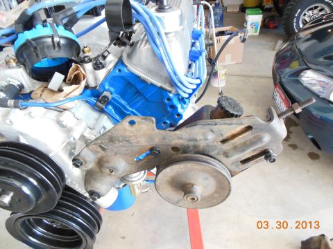 1979 Ford F-150 - Close-up of engine components including a distributor, wires, and a power steering bracket with pulleys.