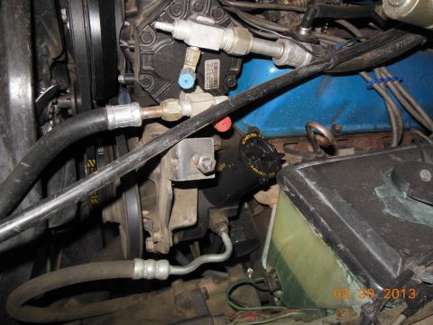 1979 Ford F-150 - Close-up view of various engine components, including the power steering reservoir and AC compressor.