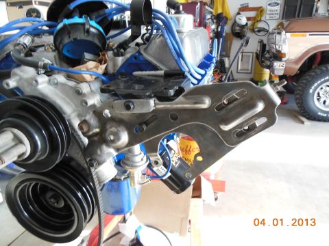 1979 Ford F-150 - Close-up of an engine assembly, with a 1979 Ford F-150 visible in the background.