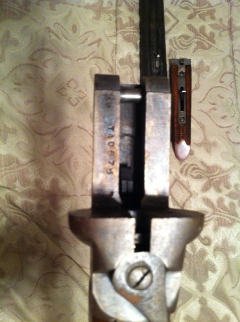2005 Ford Crown Victoria - Close-up view of a gun's internal mechanism, showing a stamped serial number.