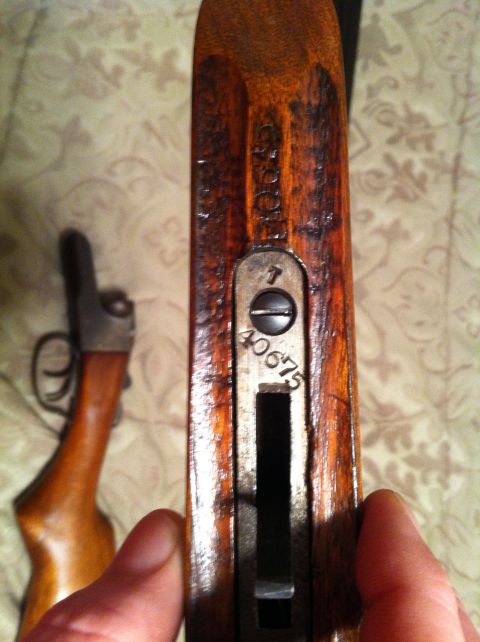 2005 Ford Crown Victoria - Wooden gun stock with visible serial numbers and metal components.
