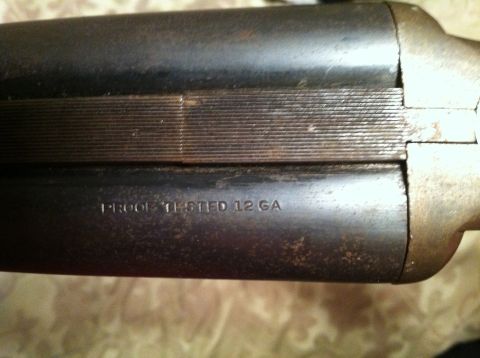 2005 Ford Crown Victoria - Close-up of a double-barreled shotgun receiver shows proof testing information.