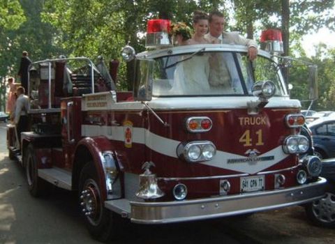 1991 Ford Crown Victoria - A wedding couple rides in the cab of a fire truck labeled "TRUCK 41".