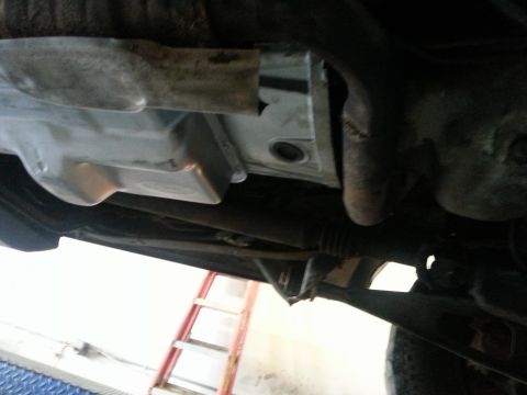 1994 Ford Bronco - Underside view of vehicle transmission pan and associated parts.
