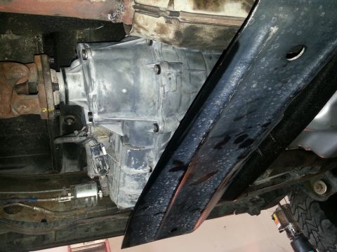 1994 Ford Bronco - Underside view of a vehicle's transmission and driveshaft, with a black frame obscuring part of the view.