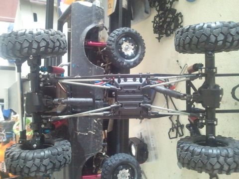 1985 Ford Bronco - The underside of an off-road vehicle chassis is shown, highlighting its suspension and large tires.
