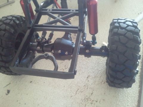 1985 Ford Bronco - Close-up view of the suspension and drivetrain of a remote control vehicle.