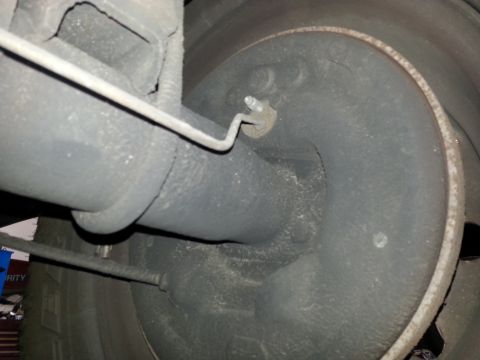 1994 Ford Bronco - Close-up view of rear brake drum and suspension components, likely from a truck or SUV.