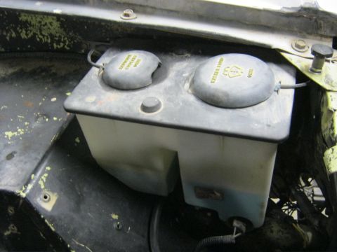 1970 Ford Bronco - Windshield washer fluid reservoir with two caps, one labeled 'Washer Fluid'.
