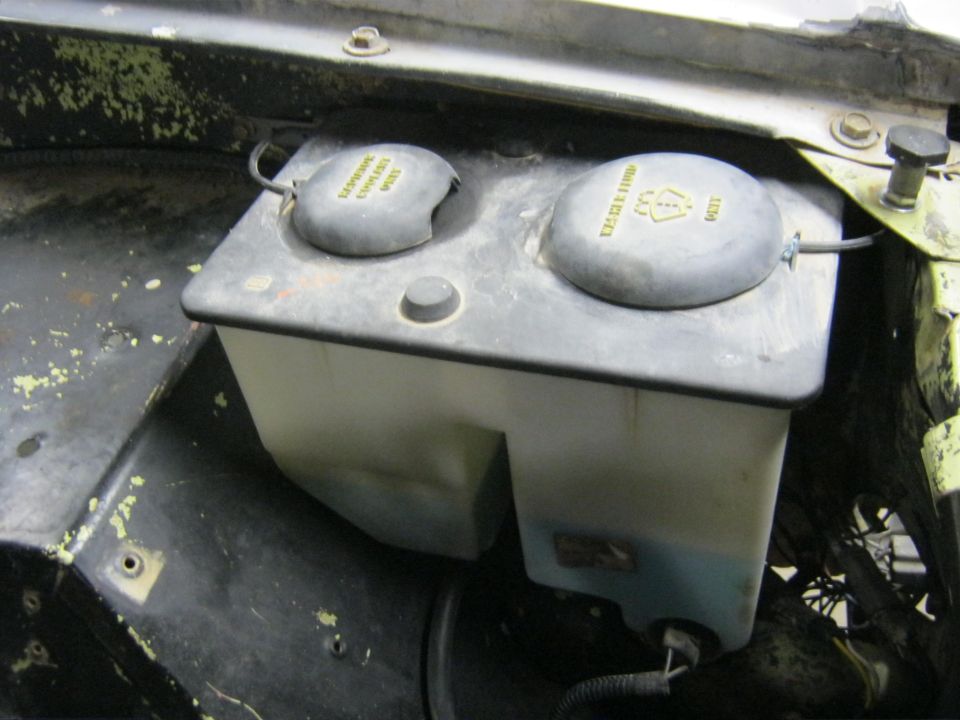 Windshield washer fluid reservoir with two caps, one labeled 'Washer Fluid'