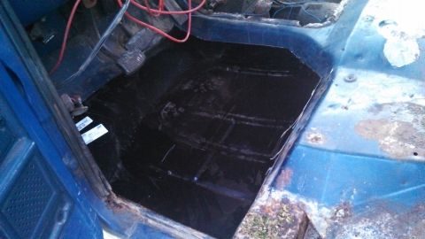 1979 Ford Bronco - The interior floor of a blue vehicle shows exposed wiring and new black carpeting has been installed.