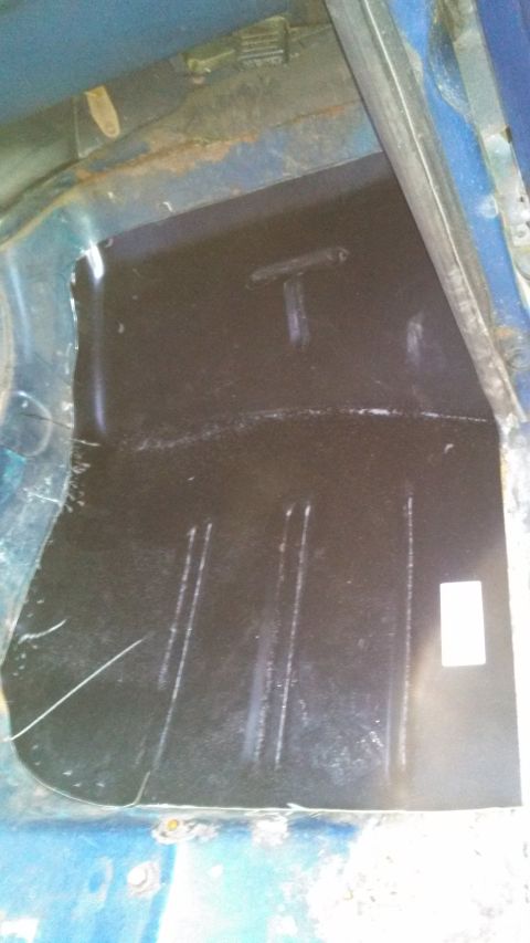 1979 Ford Bronco - The interior floor of the vehicle shows some rust and a black protective coating.