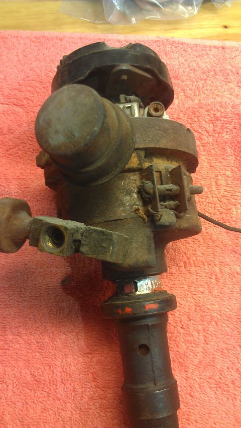 1976 Pontiac Trans Am - Close-up of a rusty automotive distributor, likely a replacement part.