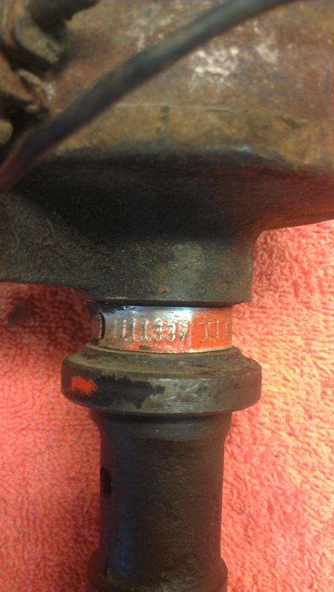 1976 Pontiac Trans Am - Distributor cap with visible part numbers stamped in orange and silver.