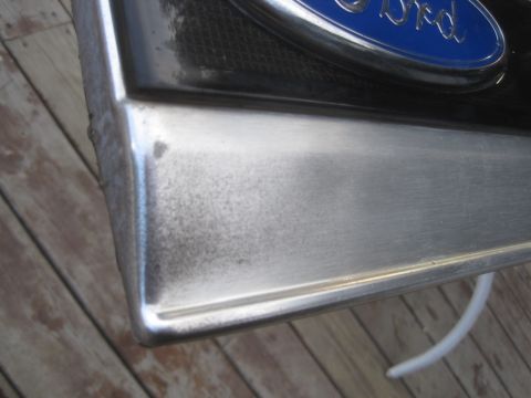 1993 Ford Bronco - A close-up shows a Ford emblem on a metal part, with a watermark from Supermotors.net at the bottom.