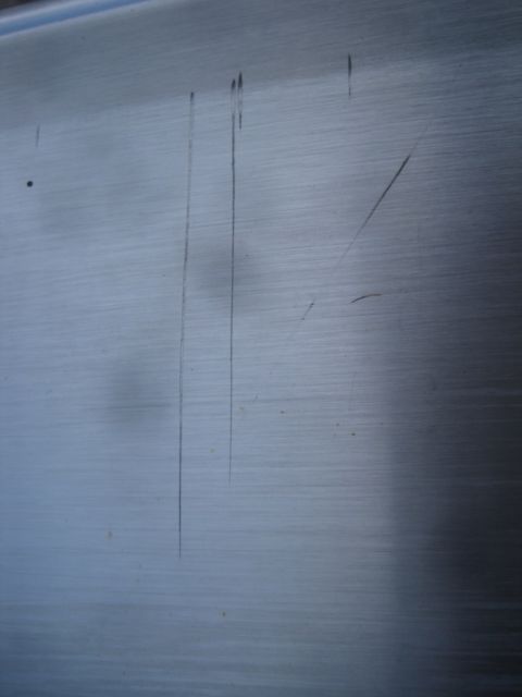 1993 Ford Bronco - This image shows a close-up of a scratched metal panel, not a 1993 Ford Bronco.