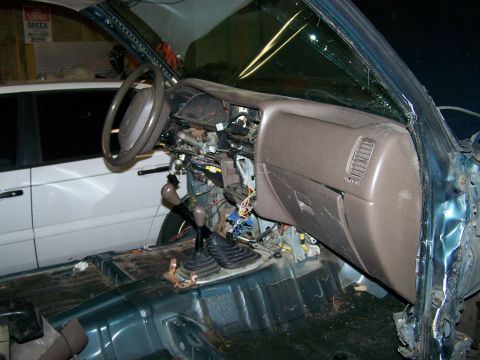 1988 Suzuki Samurai - The interior of a vehicle is shown with its dashboard and wiring exposed, suggesting a repair or modification is underway.