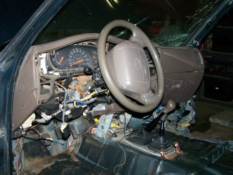 1988 Suzuki Samurai - The interior of a vehicle is shown with the dashboard disassembled, revealing exposed wiring and components.