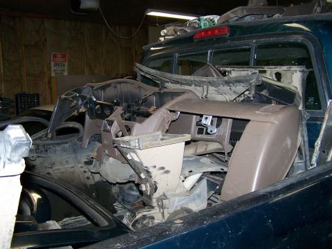 1988 Suzuki Samurai - Interior of a pickup truck filled with disassembled dashboard and interior components.