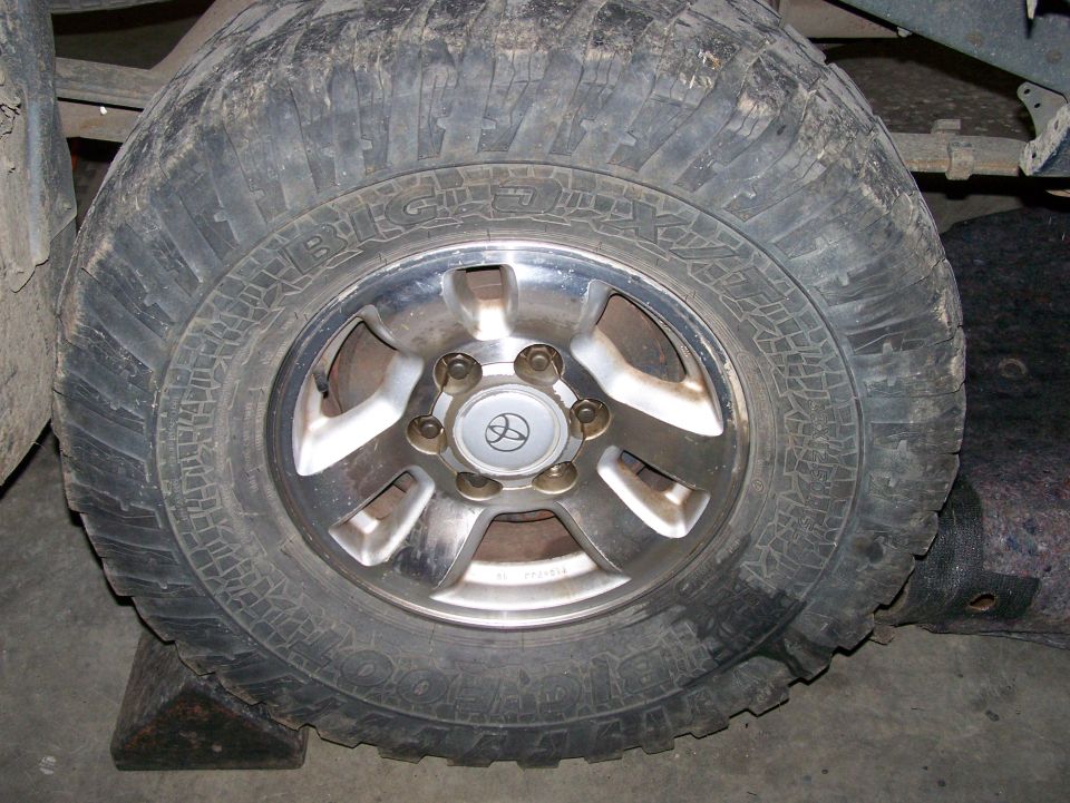 Wheel with Toyota logo and aggressive tire tread