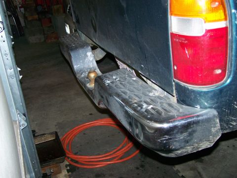 1988 Suzuki Samurai - Close-up of a vehicle's rear bumper and trailer hitch assembly.