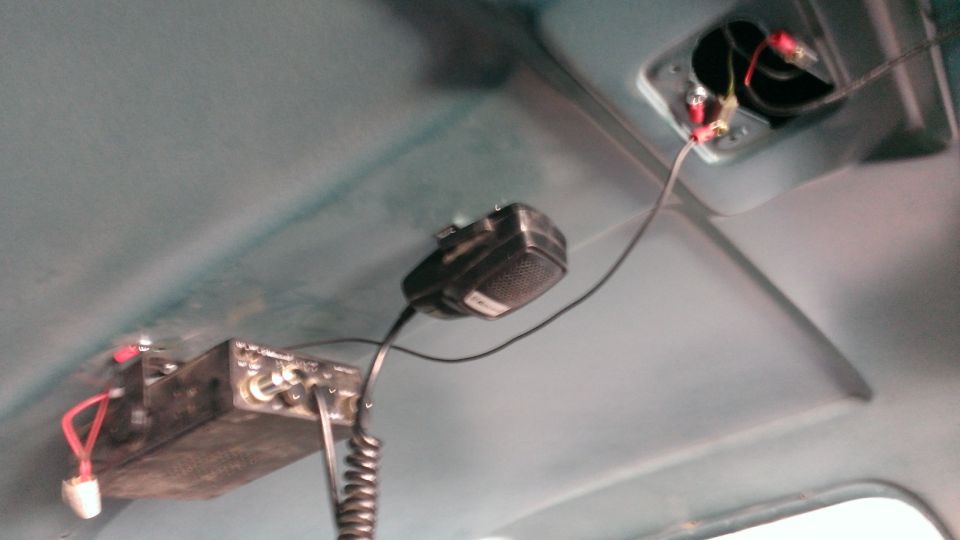 CB radio and microphone mounted on the ceiling of a vehicle