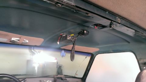 1994 Ford Bronco - Interior view of a vehicle's headliner, showing a CB radio and sun visors.
