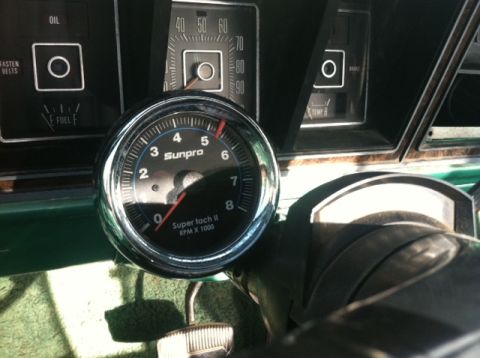 1977 Ford F-350 - Close-up of the dashboard interior, showing an aftermarket tachometer and original gauges.