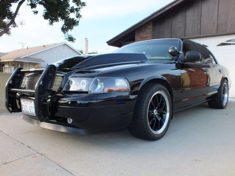 2003 Ford Crown Victoria - Modified 2003 Ford Crown Victoria parked in a driveway with a push bar and hood scoop.
