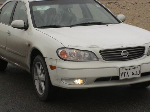 2004 Nissan Maxima - The front of a white 2004 Nissan Maxima is shown, its grille and headlights.