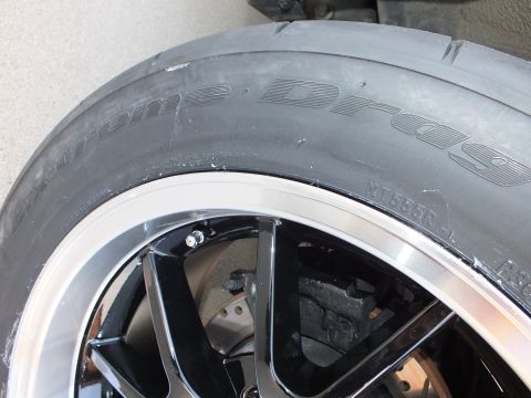 2003 Ford Crown Victoria - A close-up view of a tire and wheel assembly, showing the tread pattern and rim details.