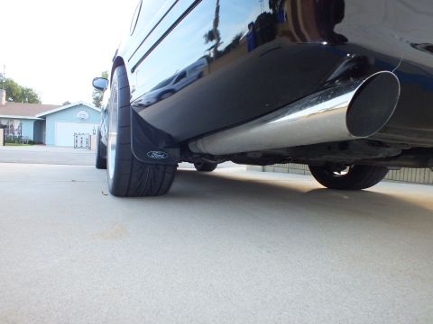 2003 Ford Crown Victoria - Rear view of a 2003 Ford Crown Victoria showing the quarter panel, mud flap, and exhaust system.