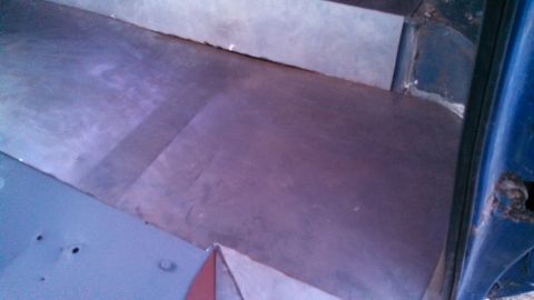 1979 Ford Bronco - The interior floor of the vehicle shows metal panels and some signs of wear and tear.