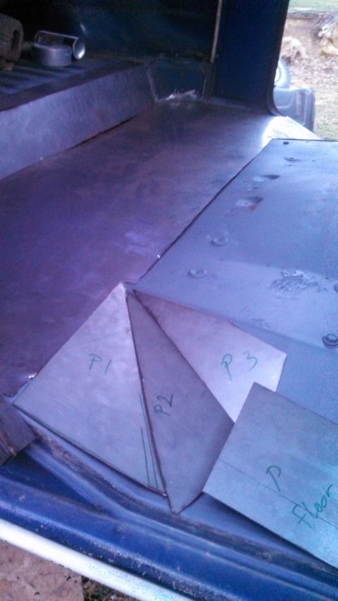 1979 Ford Bronco - Metal floor panels are laid out inside a vehicle, marked with labels for installation.
