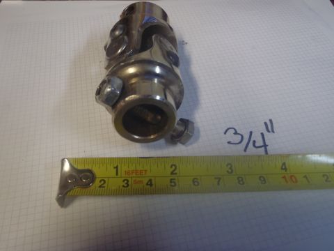 1970 Ford Bronco - A metal universal joint part is shown with a tape measure indicating its size.