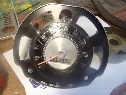 1970 Ford Bronco - A Ford instrument cluster is shown, with the odometer displaying 07740 miles. Part number information is visible on the lower edge.