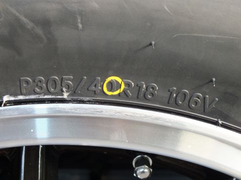 2003 Ford Crown Victoria - Close-up of a tire showing the size P305/40R18 and speed rating 106V.