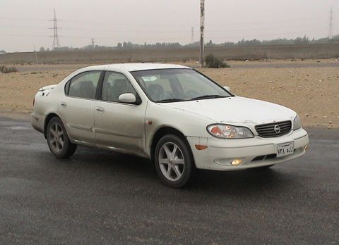 2004 Nissan Maxima - A white 2004 Nissan Maxima sedan is seen from the front three-quarter angle on a paved road.